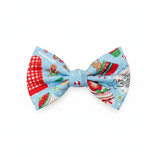 Christmas-themed bow tie with gingerbread men and cookies on a blue background
