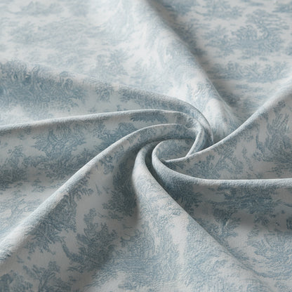 Textured blue and white toile patterned fabric
